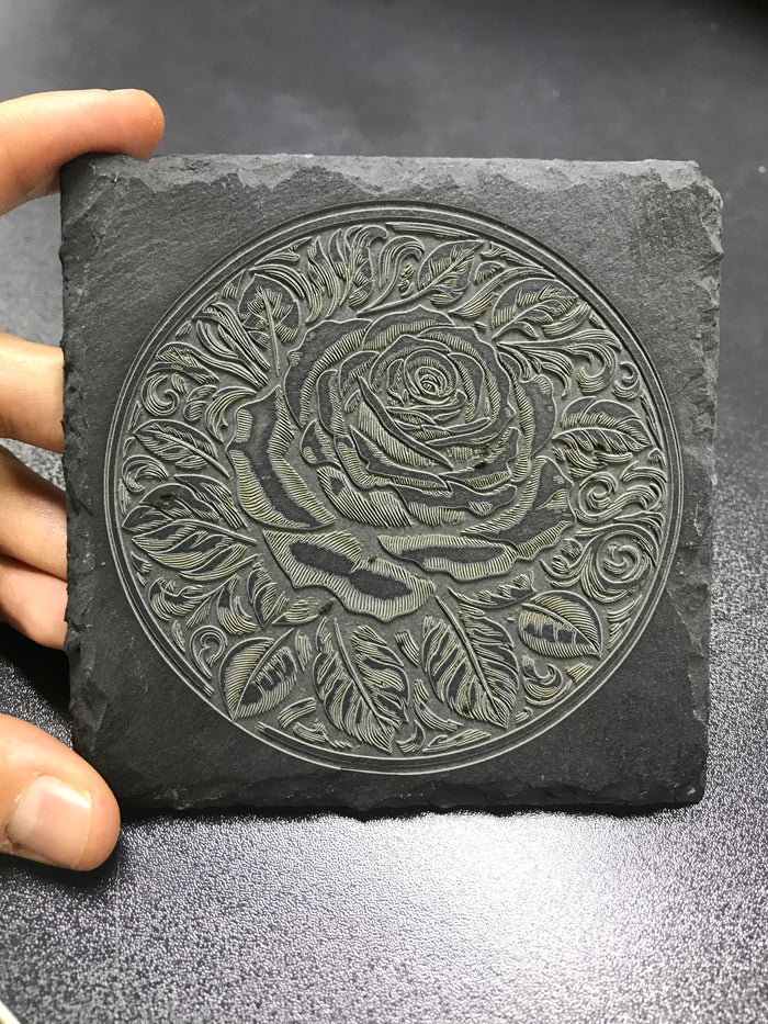 A blooming rose laser engraved on slate